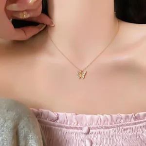 Detailed view of an 18k gold plated butterfly pendant necklace with sparkling zircons