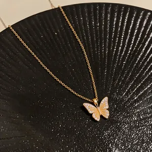 Detail view of 18k gold plated butterfly pendant necklace with sparkling zirconia.