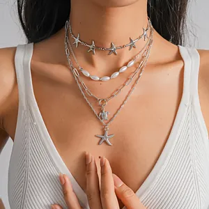 Vintage layered necklace set with starfish, sea turtle pendants and elegant pearls.