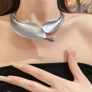 Close-up of elegant matte silver leaf choker necklace on model