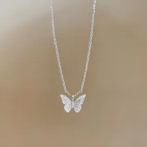 Detailed view of an 18k gold-plated butterfly pendant necklace set with sparkling zircons
