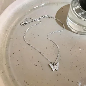 Detailed view of an 18k gold plated butterfly pendant necklace with sparkling zircons.