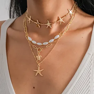 Close-up of a 4-piece layered necklace set with starfish and turtle pendants