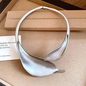 Close-up of matte silver leaf choker necklace in a vintage minimalist style.