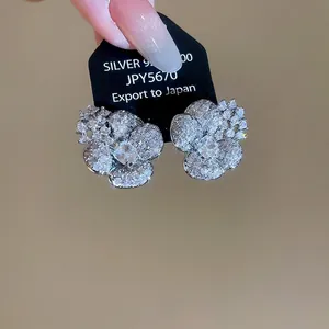 Elegant sparkling silver-tone flower stud earrings with brilliant clear zircon stones