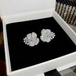 Elegant silver-toned flower stud earrings featuring sparkling cubic zirconia stones