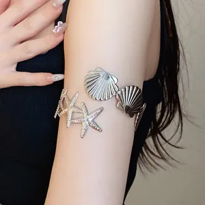Bohemian silver metal starfish and seashell arm cuff worn on upper arm for women