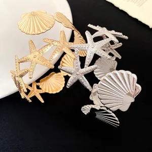 Fashionable metal starfish and shell arm cuff bracelet in gold and silver finish