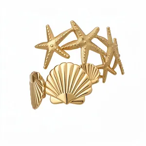 Gold starfish and seashell arm cuff bracelet with elegant ocean theme design