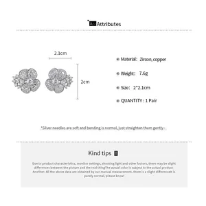 Detailed view of zircon flower stud earrings with size and material specifications.