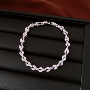 Detailed macro view of elegant leaf-patterned marquise zircon bracelet on black display box