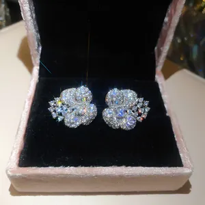 Close-up of sparkling flower stud earrings set with cubic zirconia in a pink velvet box