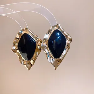 Elegant vintage irregular gold stud earrings featuring deep navy dripping oil enamel