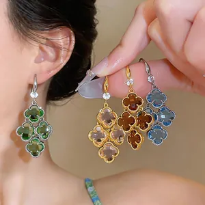 Detailed view of French retro clover drop earrings with colorful zircon and gold finish