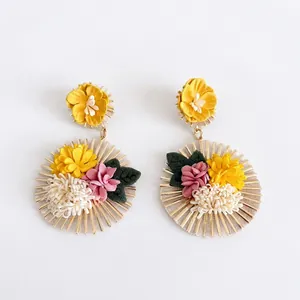 Bohemian floral statement earrings with gold-toned radial design and fabric petals.