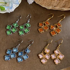 Detailed macro view of French vintage zircon clover tassel earrings in four colors