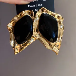 Vintage geometric irregular stud earrings with gold plating and black enamel inlay