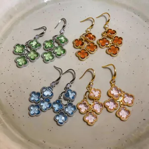 Close-up detail of vintage flower drop earrings with colorful gemstones and zircon