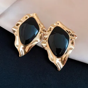 Vintage irregular geometric stud earrings with gold-tone frames and black drip oil centers