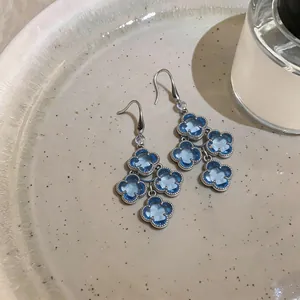 Detailed view of elegant blue zircon flower tassel earrings with vintage French charm