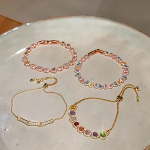 Detailed view of four elegant gold-plated bracelets featuring colorful zircon stones