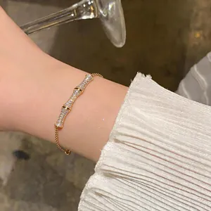Detailed close-up of a gold bamboo-joint bracelet featuring sparkling cubic zirconia inlay