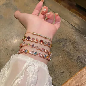 Detail view of colorful zircon stackable bracelets on wrist with French vintage style.