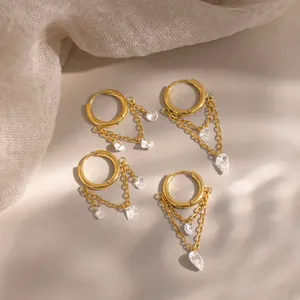 Professional close-up of 18K gold plated earrings with sparkling white zircon tassels