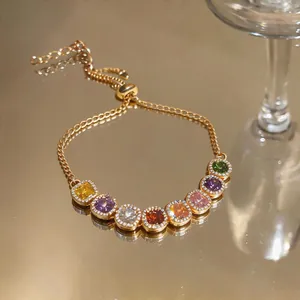 Detailed close-up of a colorful zircon square bracelet with adjustable gold-tone chain
