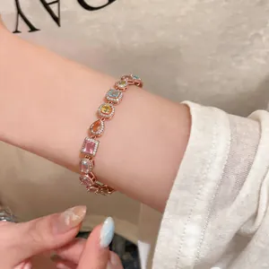 Close-up detail of multi-colored zircon bracelet with vintage rose gold setting