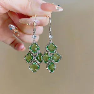 Detailed view of French vintage green zircon flower tassel earrings with clover design