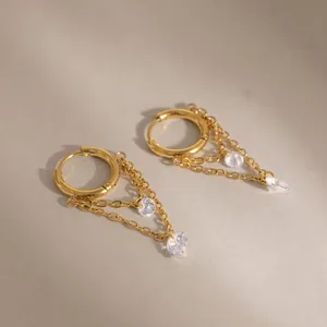 Detailed close-up of 18K gold plated stainless steel earrings with white zircons.