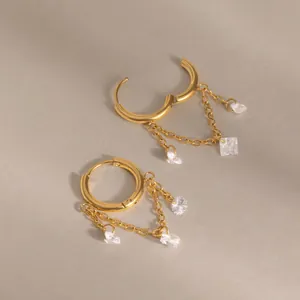 Detailed view of 18K gold-plated stainless steel earrings with white zircon tassels