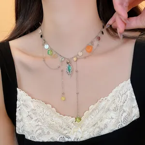 Detailed view of an elegant French style silver necklace with colorful beads on a model.