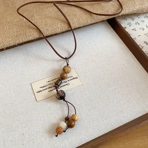 Detailed view of handcrafted wooden beads on this retro ethnic style long necklace