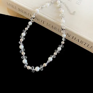 Close-up view of French style pearl necklace with silver accents and transparent flower beads