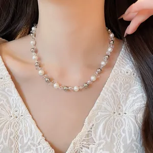 French style pearl and silver bead necklace shown on a model's neck for a summer look.
