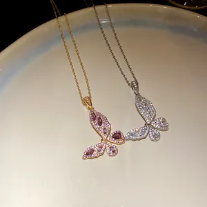 Macro view of delicate butterfly necklaces with shimmering zircon stones in two tones