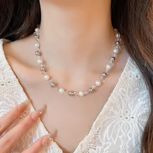 Close-up of an elegant French style pearl and silver bead choker necklace on a model's neck