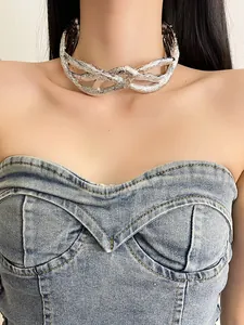 Close-up view of a chic metallic crumpled twisted choker necklace worn by a female model