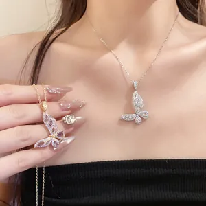 Detailed view of elegant zircon butterfly pendant necklaces on an Asian model's neck
