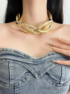 Detailed close-up of a chunky gold intertwined twisted choker necklace on a female model