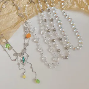 Close-up of various French style pearl and clear beaded necklaces with colorful accents.