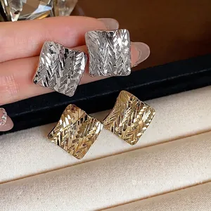 Elegant textured square stud earrings in polished silver and gold finishes for women