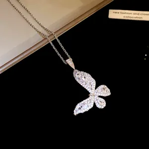 Close-up of sparkling zircon butterfly pendant on a delicate silver chain necklace