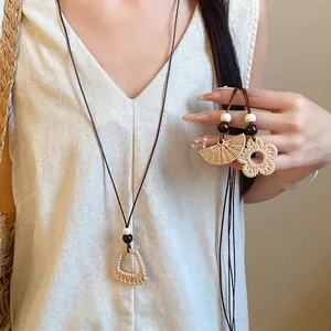Boho chic wax rope necklace featuring woven fan and flower resin pendants for women.