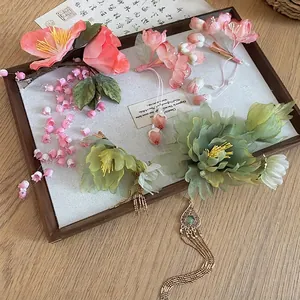 Handmade pink lily of the valley hair clips with silk flowers and elegant gold tassels
