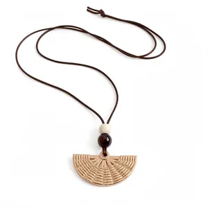 Minimalist ethnic style necklace with textured gold fan pendant and beaded wax cord