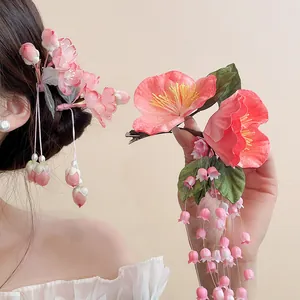 Close-up of pink lily of the valley flower hair clip with flowing tassels for Hanfu