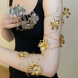 Gold and silver metallic flower arm cuffs with textured petals on model